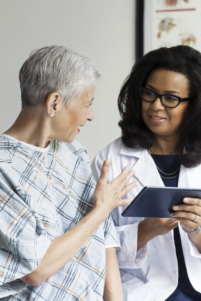 Female Doctor Discussing Medical Report With Patient In Hospital